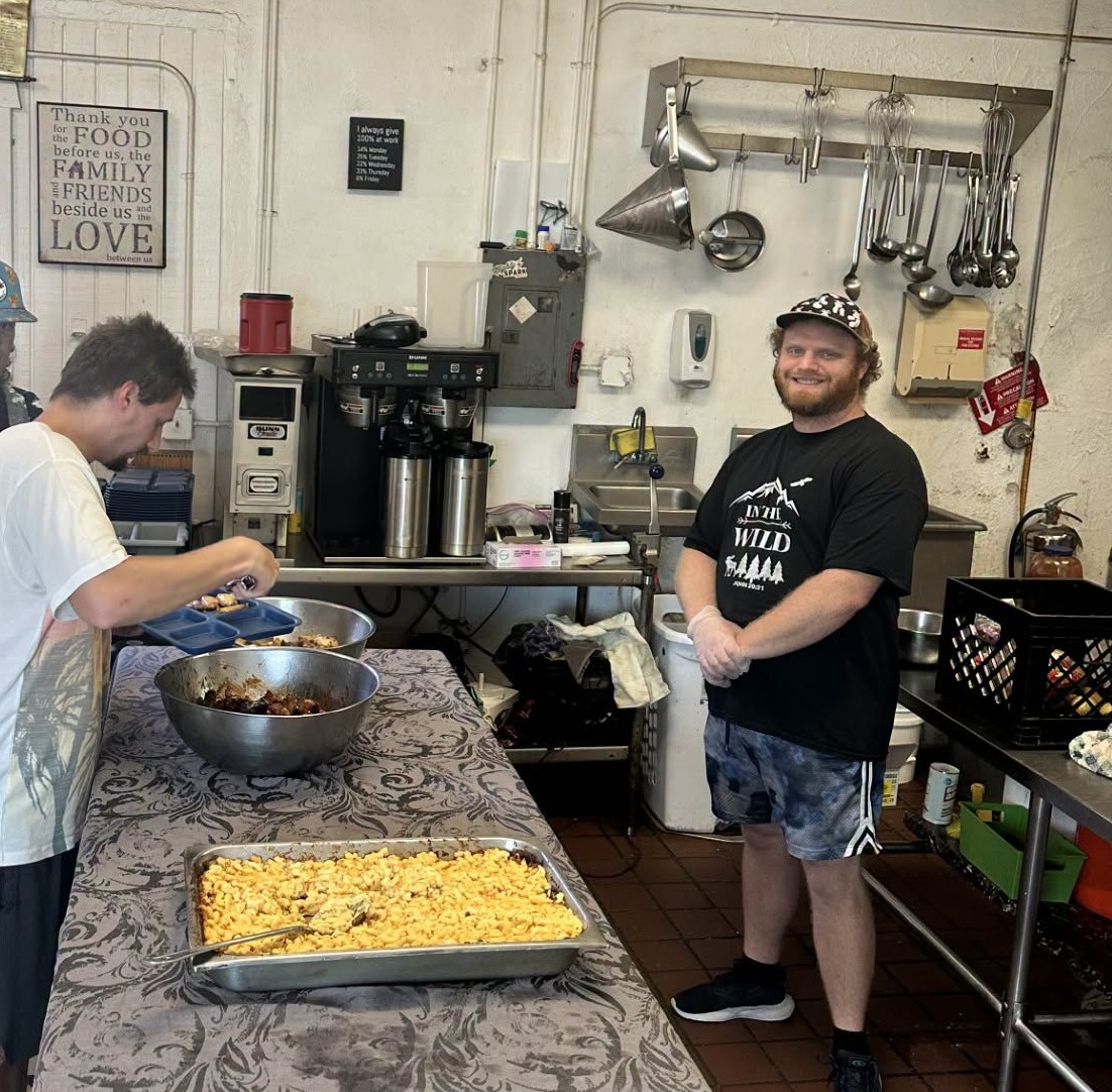 Volunteer Peter Chell serving in the CITA kitchen
