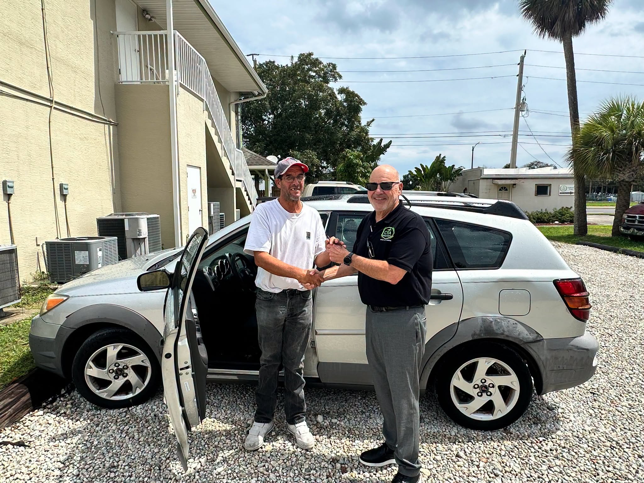 Sean receiving a donated vehicle after beginning a new job